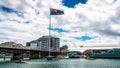 Sydney Darling Harbour panorama with Giant Australian flag and Pyrmont bridge with overcast weather in NSW Australia Royalty Free Stock Photo