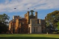 Full view of front Sydney Government House, Official Residence of Governor, with dense trees, New South Wales NSW, Australia