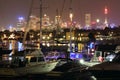 Pulsating city Sydney at harbor with sailing boats by night Royalty Free Stock Photo