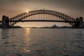 Sydney Harbour Bridge seen across the water at sunset Royalty Free Stock Photo