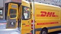 DHL delivery van in Sydney CBD area with postman opening back door on street
