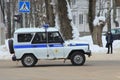 15-02-2020 Syktyvkar, Russia. A silver-blue police car with flashing beacons rides along a city street in winter
