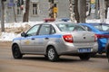 15-02-2020 Syktyvkar, Russia. A silver-blue police car with flashing beacons rides along a city street in winter