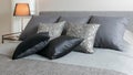 Sylish bedroom interior with black patterned pillows on bed