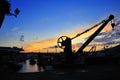 Syluet of lift crane in the port at sunset