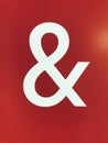 symbol of ampersand on red background, closeup of photo