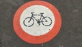 Symbol of a bicycle in red circle printed onto sidewalk depicting this is a zone forbidden for riding bicycle