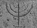 Engraved menorah in stone background