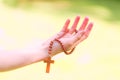 Symbol of christianity, wooden rosary in hands Royalty Free Stock Photo