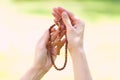 symbol of christianity, wooden rosary in hands Royalty Free Stock Photo