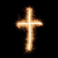 Symbol of crucifix made with sparks on a black background