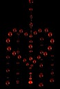 Symbol of a crying heart made of red water drops on a dark background, motion blur Royalty Free Stock Photo