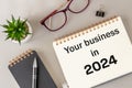 Symbol of the development of your business in 2024, Conceptual words written in an open notebook on the boss desk, New year, ne