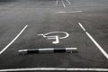 Symbol of disabled parking car on black asfalt floor