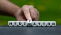 Symbol for doing meditation instead of taking medication. Hand turns dice and changes the word medication to meditation Royalty Free Stock Photo