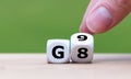 Symbol for the duration of the secondary school in Germany. Hand turns a dice and changes the expression G8 8 years to G9