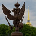 Symbol of the Empire on the background of the symbol of St. Petersburg.