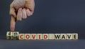 Symbol for a fourth wave of the covid-19 corona virus. Doctors turns cubes, changes words 3rd covid wave to 4th covid wave.