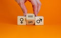 Symbol for gender equality. Hand turns a cube and changes a unequal sign to a equal sign between symbols of men and women.