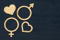 A symbol of gender equality made of plywood. Black wooden background. Male and female symbols Royalty Free Stock Photo