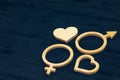 A symbol of gender equality made of plywood. Black wooden background. Male and female symbols Royalty Free Stock Photo