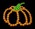 Symbol Halloween - a pumpkin. Composed of small round candies.