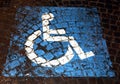 Symbol of handicapped parking painted on porphyry in the street Royalty Free Stock Photo