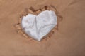 A symbol of the harm of salt to the heart, a cardiogram on white salt in a paper brown heart