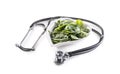 Symbol of healthy heart with stetoscope and heart-shaped bowl full of baby spinach leaves on an isolated white background