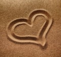 Symbol of heart is drawn on sand Royalty Free Stock Photo