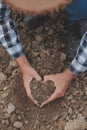 Symbol heart earth day. Handful of dirt hands heart shape. Farm organic earth. Farmer hands soil ground earth dirt garden soil Royalty Free Stock Photo