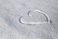 The symbol of the heart painted on the fresh white snow Royalty Free Stock Photo