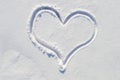 symbol of the heart, painted on the fresh white snow close up Royalty Free Stock Photo