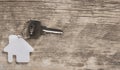 House symbol with silver keys on wood. Real estate concept Royalty Free Stock Photo