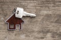 House symbol with silver keys on wood. Real estate concept Royalty Free Stock Photo