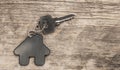 House symbol with silver keys on wood. Real estate concept Royalty Free Stock Photo