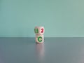 Symbol for limiting global warming. Turned a cube and changed the expression 2 C to 1.5 C, or vice versa. Beautiful grey table,
