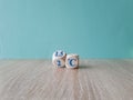 Symbol for limiting global warming. Turned a cube and changed the expression 2 C to 1.5 C, or vice versa. Beautiful wooden table,