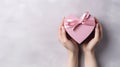 Symbol of Love. Close-Up on Female Hands Holding a Heart-Shaped Gift for Valentine's Day, Birthday, Mother's Day Royalty Free Stock Photo