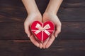 Symbol of love, female hands holding heart shaped gift Royalty Free Stock Photo