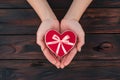 Symbol of love, female hands holding heart shaped gift Royalty Free Stock Photo