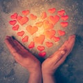 The symbol of love and health is the heart in male hands. The burning heart is laid out of small hearts in male palms. Royalty Free Stock Photo