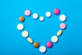 Symbol of love heart of multicolored tablets.
