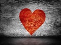 Symbol of love painted on murky brick wall Royalty Free Stock Photo