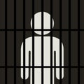 Symbol of man is behind bars in the dark place
