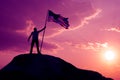 The symbol of a man with the flag of the United States stands on the top of the mountain Royalty Free Stock Photo