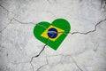 The symbol of the national flag of Brazil in the form of a heart on a cracked concrete wall Royalty Free Stock Photo