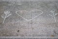 A symbol of Nature Love on a pavement in a park.