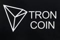 Symbol of new cryptocurrency - Tron Coin on black grunge background