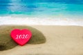 Symbol from number 2020 on the big heart on the sandy beach Royalty Free Stock Photo